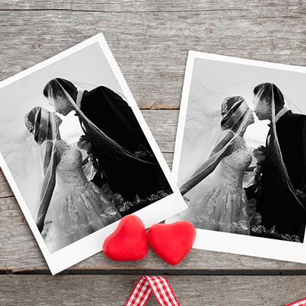 Black-and-white wedding photos with two red hearts on a rustic wooden background