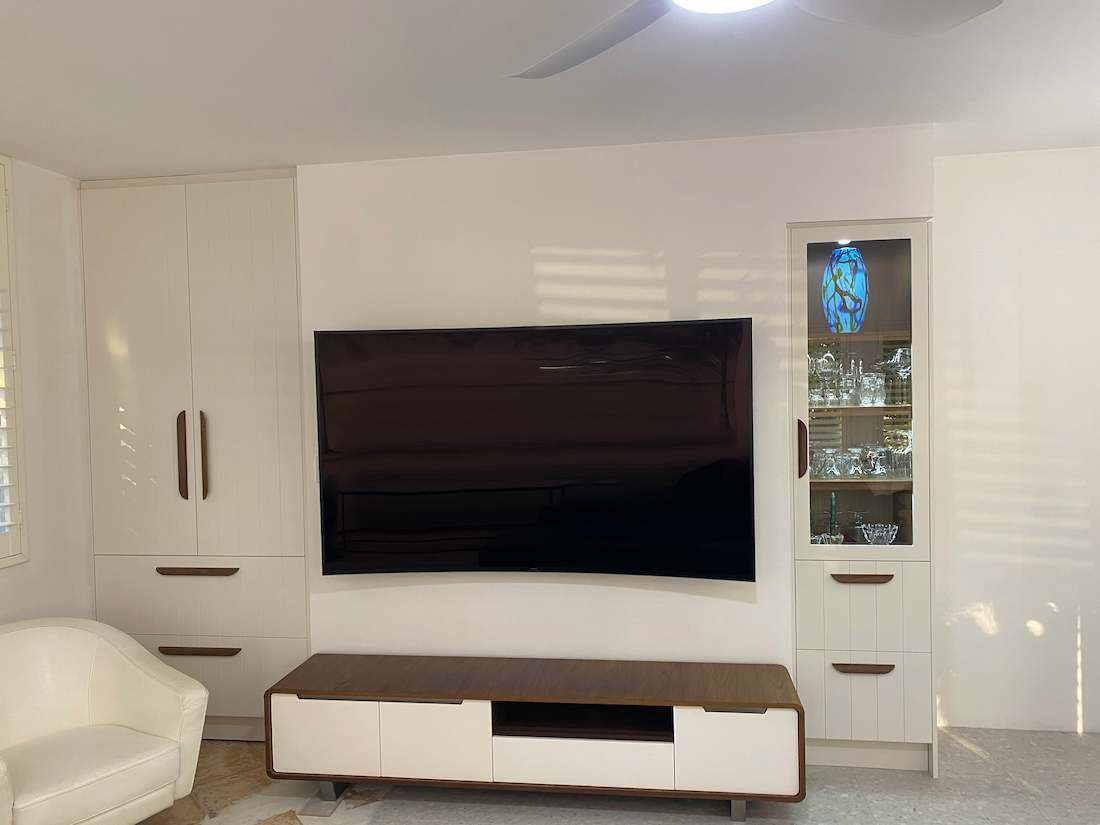 A Living Room with A Flat Screen Tv on The Wall — Nick Hall Builder in Coolum, QLD