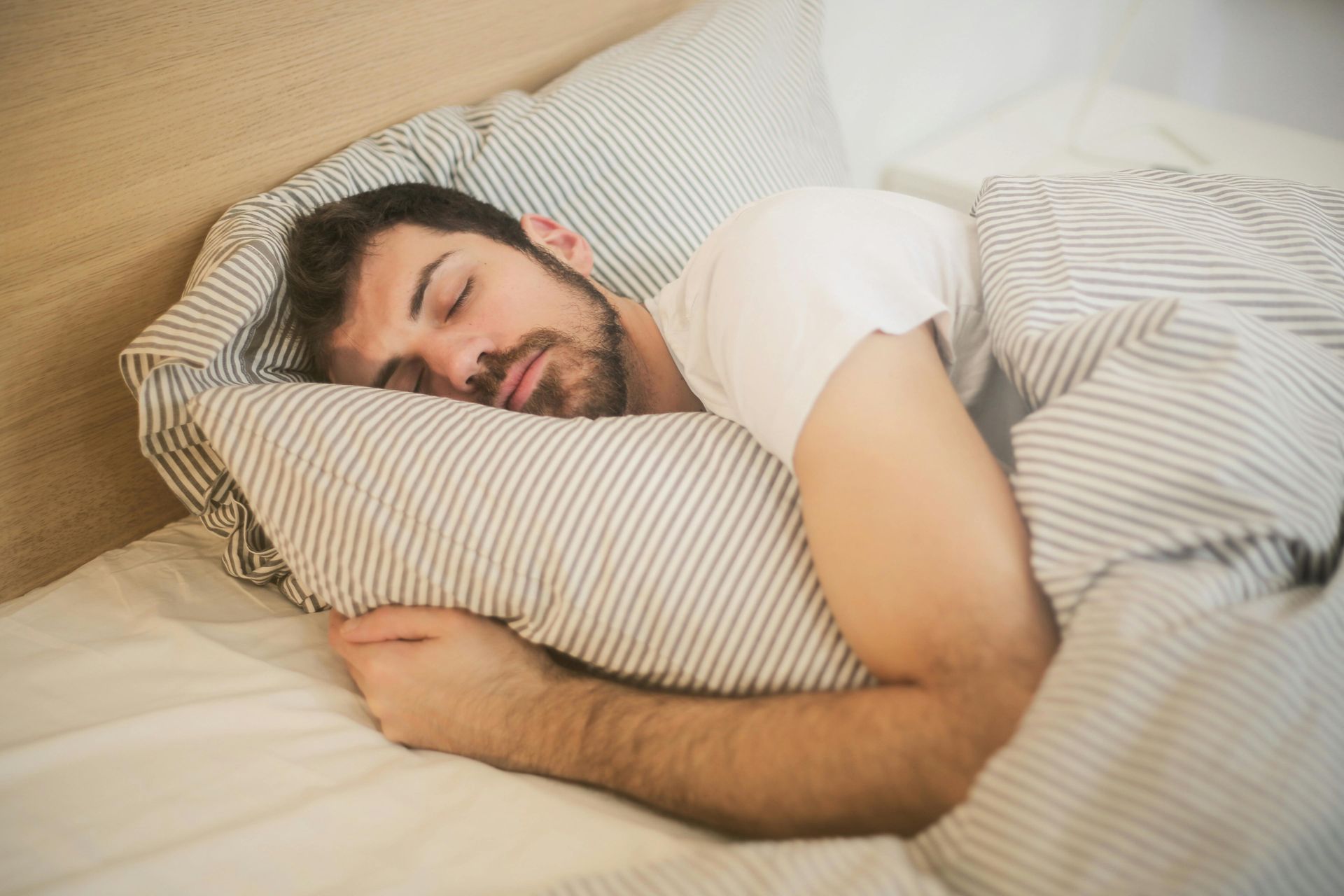 Man Sleeping Holding Pillow