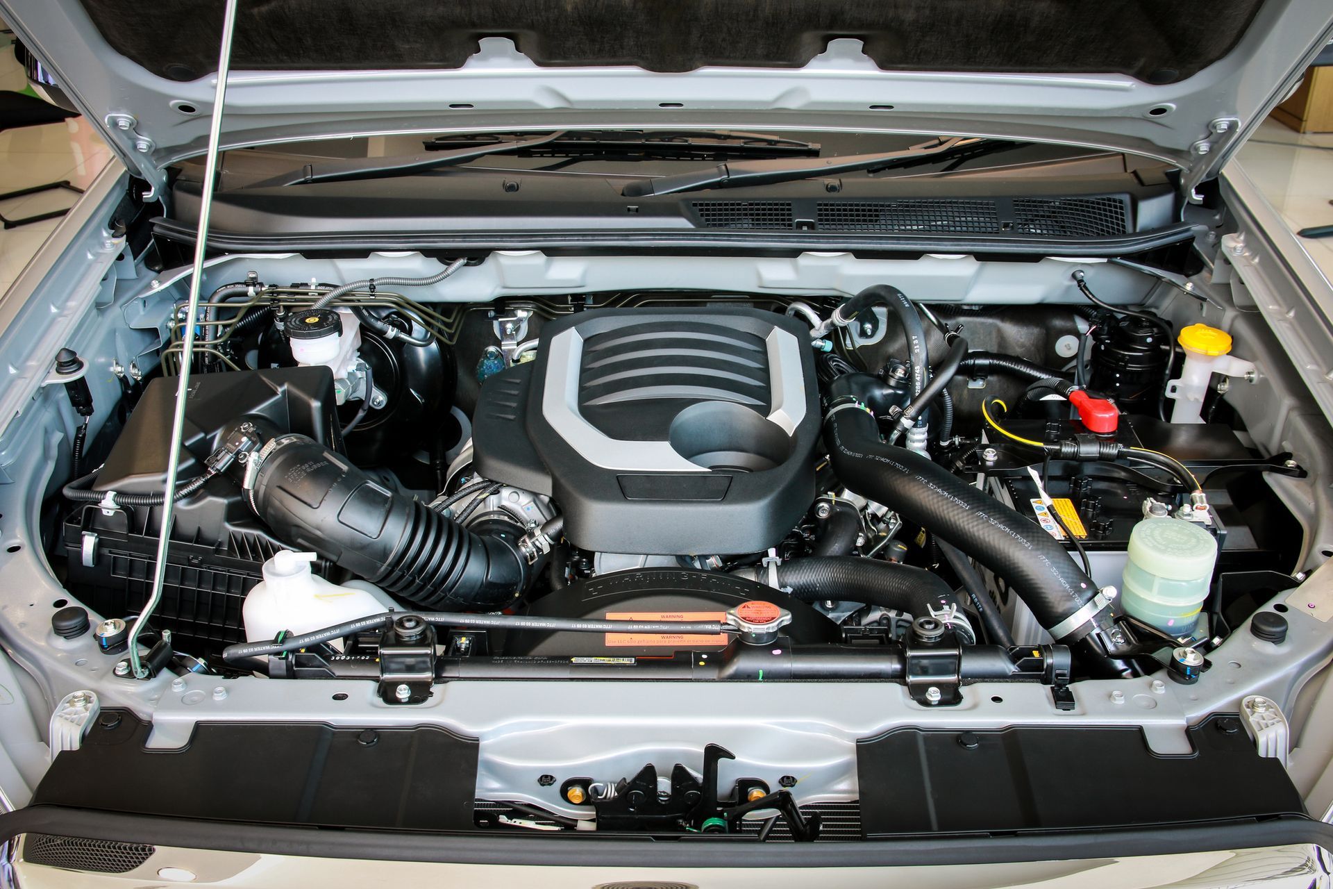 The engine of a car is shown with the hood open.