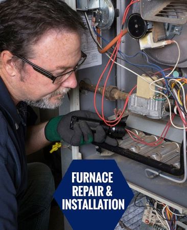 Technician Looking Over A Gas Furnace