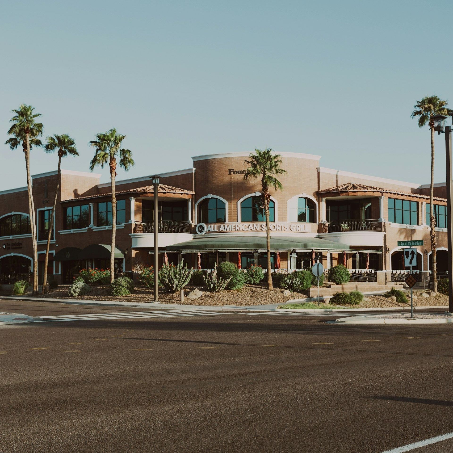A large building with palm trees in front of it