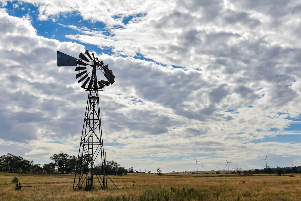A Windmill in a Field With a Cloudy Sky in the Background — Nelson Keane & Hemingway Lawyers in Dubbo, NSW