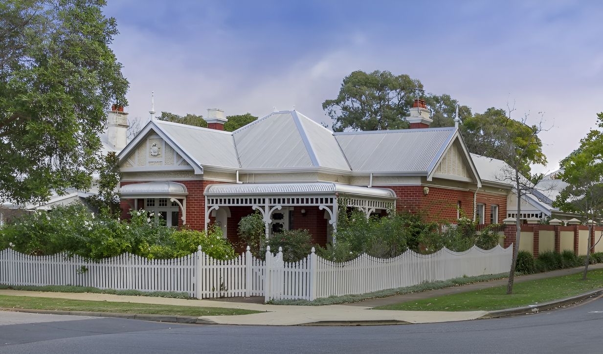 A Brick House With a White Picket Fence Around It — Nelson Keane & Hemingway Lawyers in Narromine, NSW