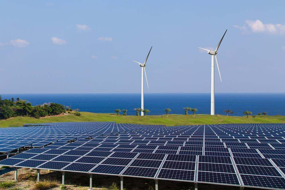 Solar Panels In The Foreground With Wind Turbines — Nelson Keane & Hemingway Lawyers in Dubbo, NSW