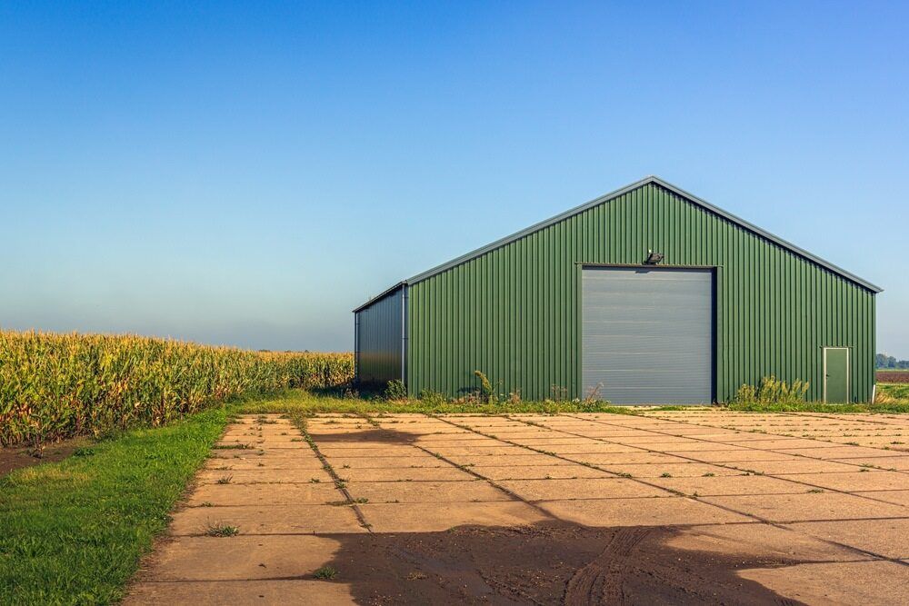 A Green Barn is Sitting in the Middle of a Field — Nelson Keane & Hemingway Lawyers in Narromine, NSW
