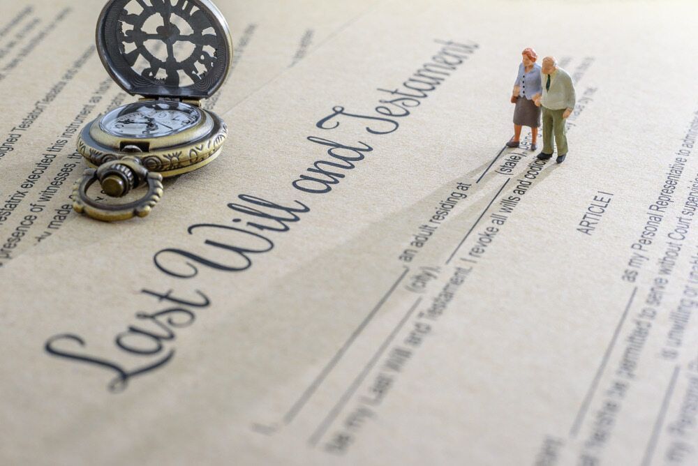A Pocket Watch is Sitting on Top of a Last Will and Testament — Nelson Keane & Hemingway Lawyers in Narromine, NSW