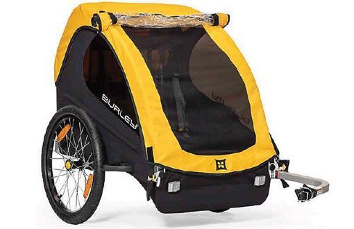 Yellow and black Burley child bike trailer, with mesh window and two wheels.