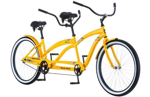 Yellow tandem bicycle with black accents and white-walled tires.
