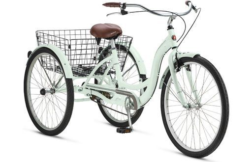 Mint green adult tricycle with a large rear basket and brown seat.