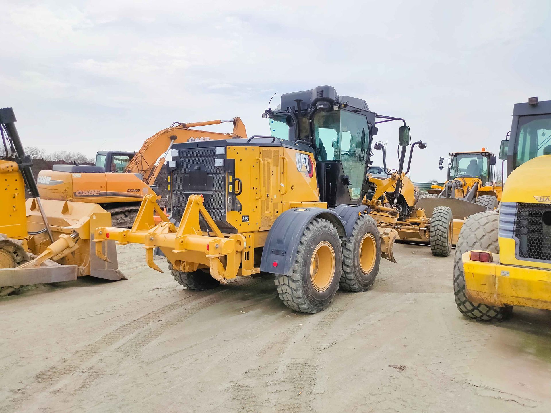 a row of construction vehicles including a case tractor