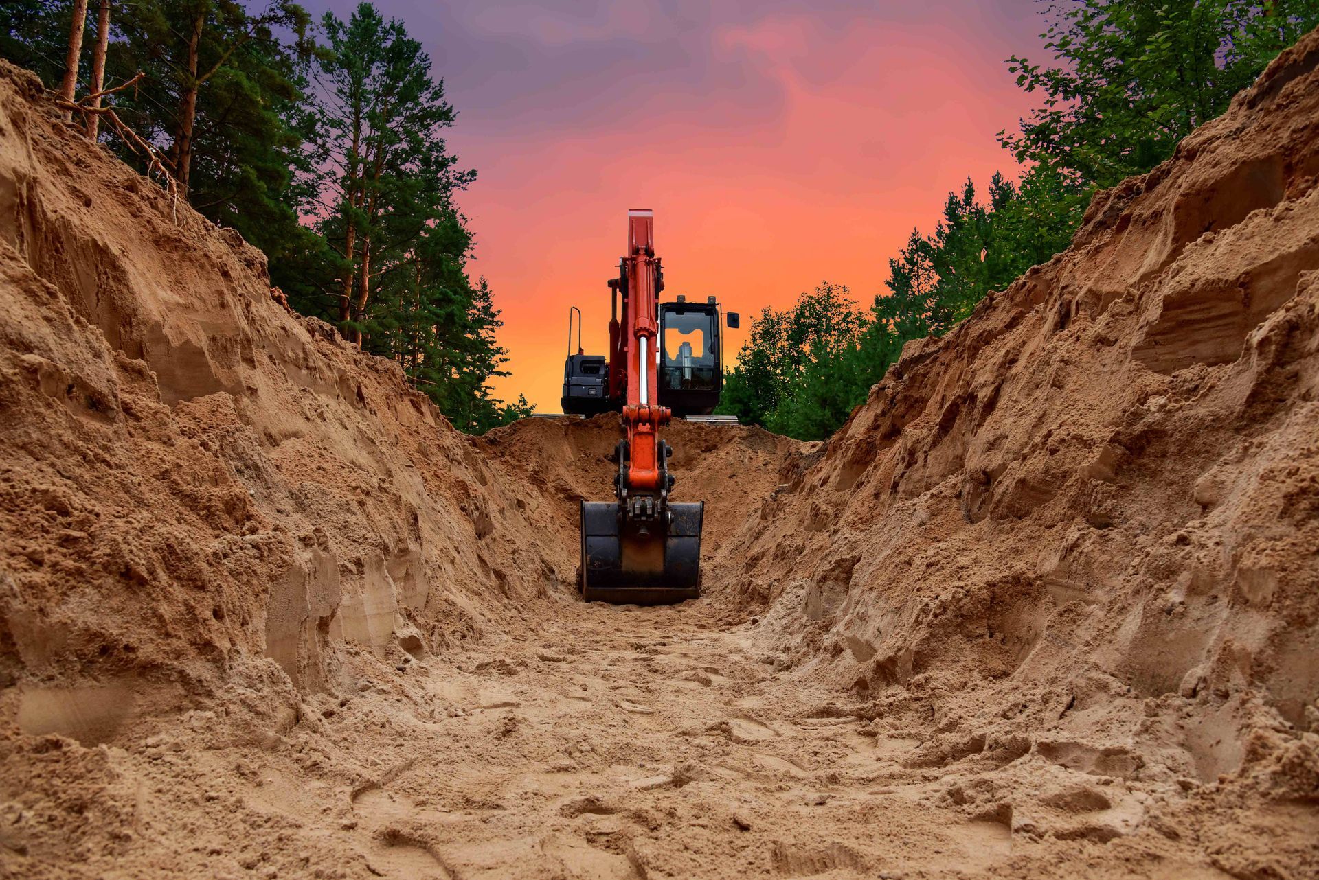 an orange excavator is digging a hole in the dirt