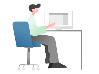 A man is sitting at a desk in front of a computer.