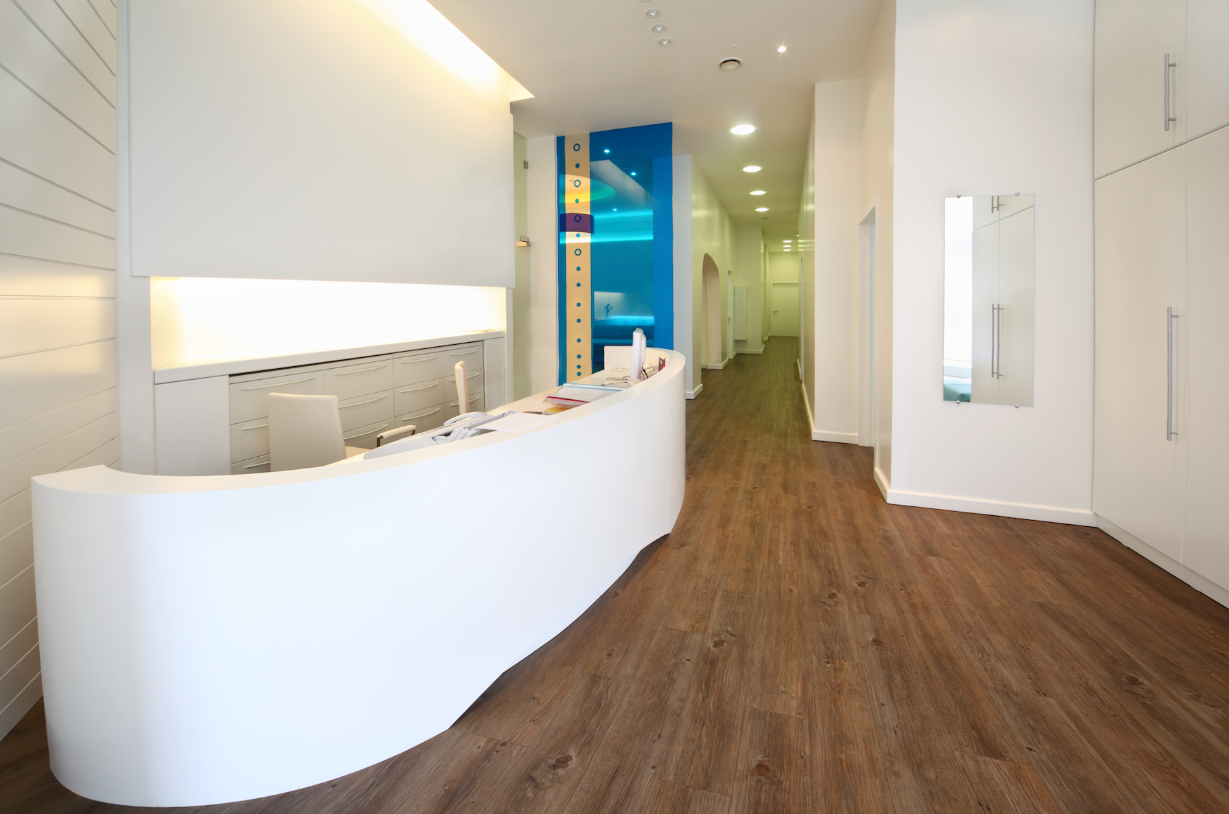 A long hallway with a white counter in the middle