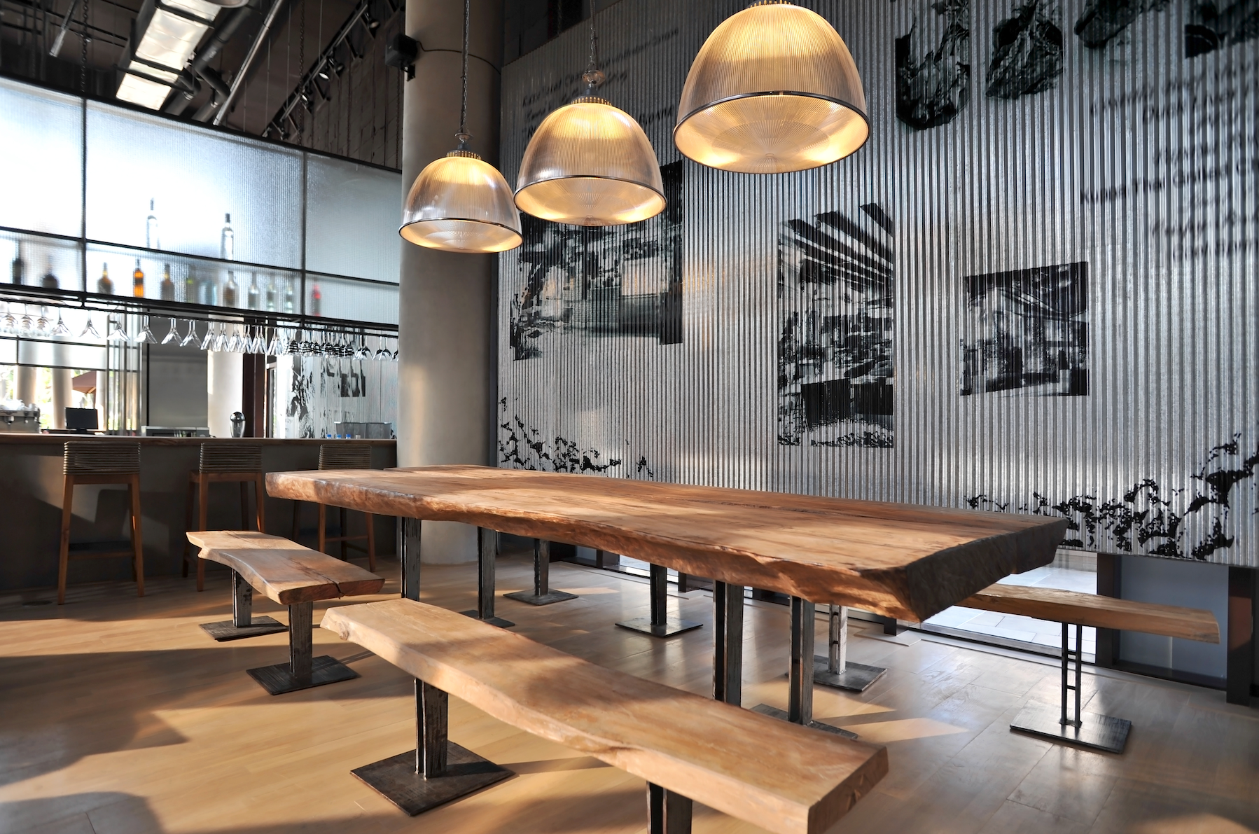 A restaurant with a long wooden table and benches