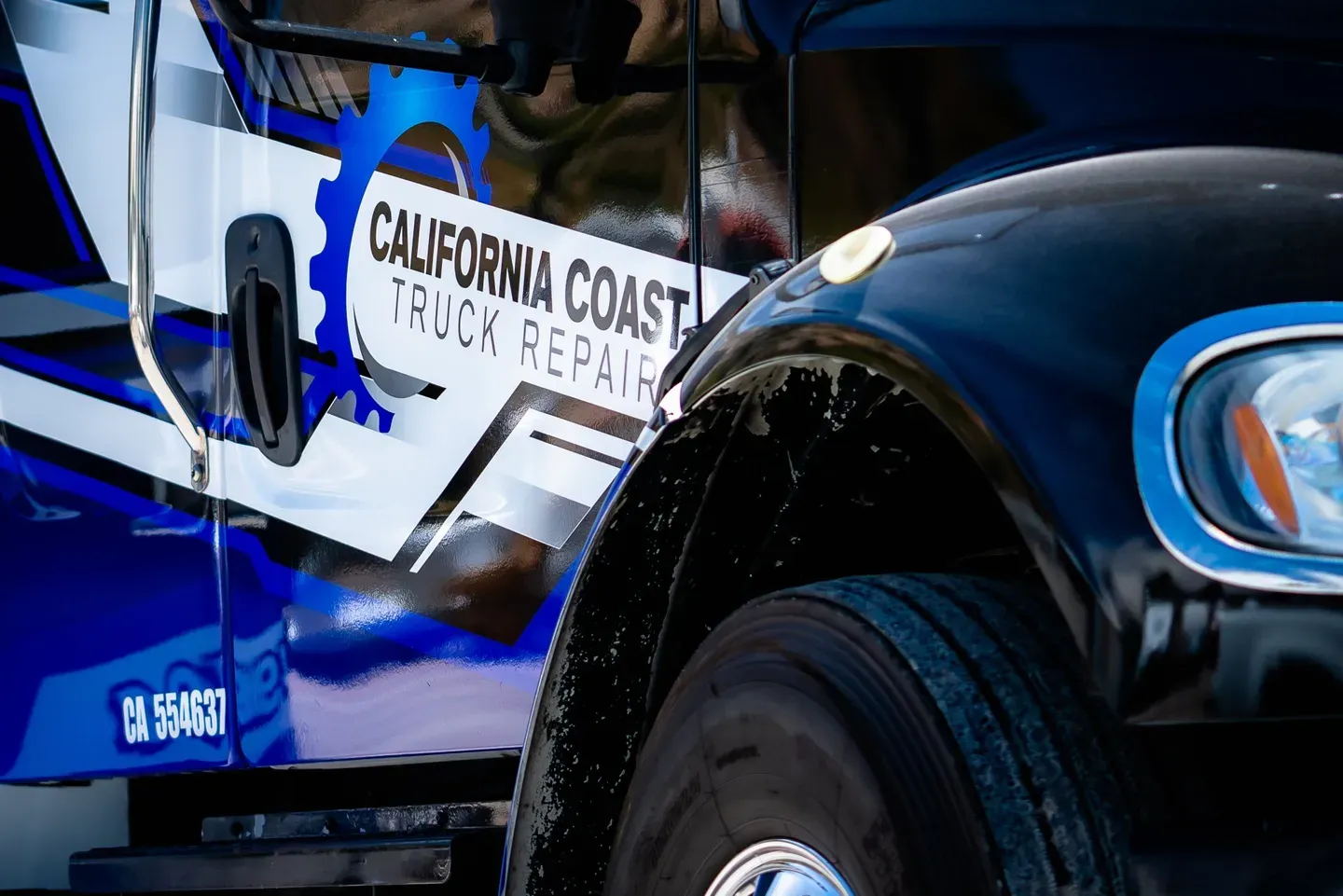 Close-up of a blue and black truck featuring a 