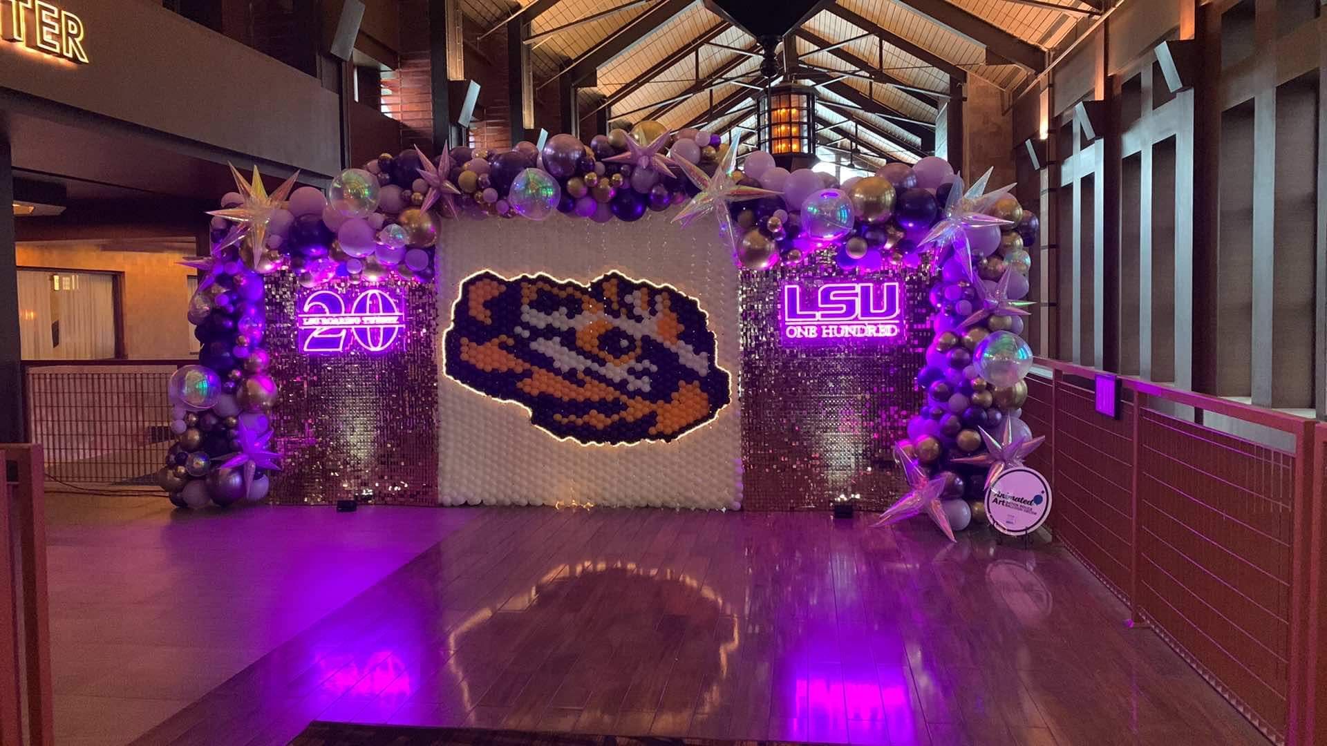 Corporate Balloon Decor at L'Auberge Casino in Baton Rouge. The huge eye of the tiger balloon mural with gold Shimmer walls on both sides. The eye of the tiger is outlined in LED adding lighting effects for an awesome entrance