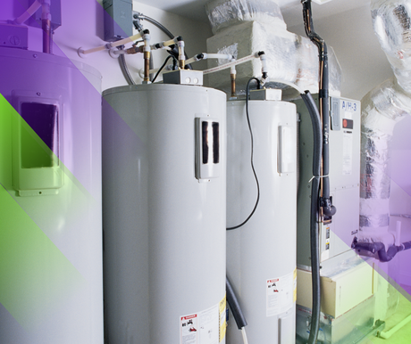 Water heaters in a utility room with pipes and ductwork.
