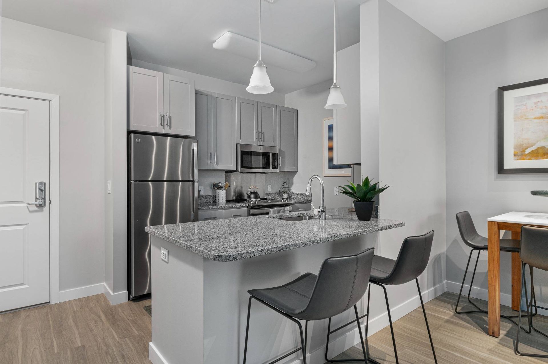 Modern kitchen at Traders Row with kitchen island and designer lighting.