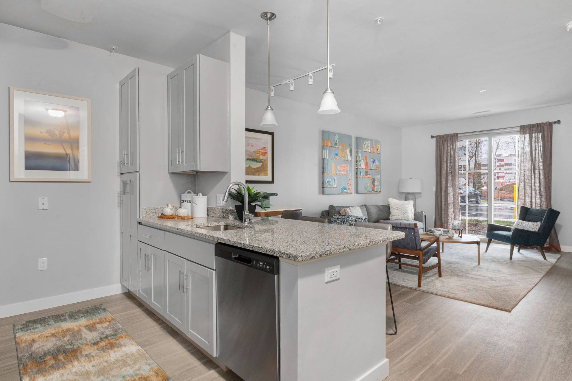Traders Row luxury apartment with kitchen oversees living room and balocny.