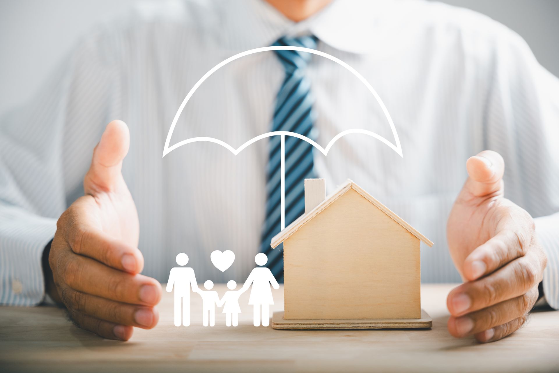Hands protecting a model house, family, and umbrella icon, symbolizing insurance coverage.