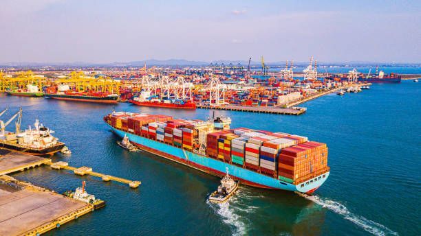 Cargo ship at sea, loaded with colorful shipping containers.