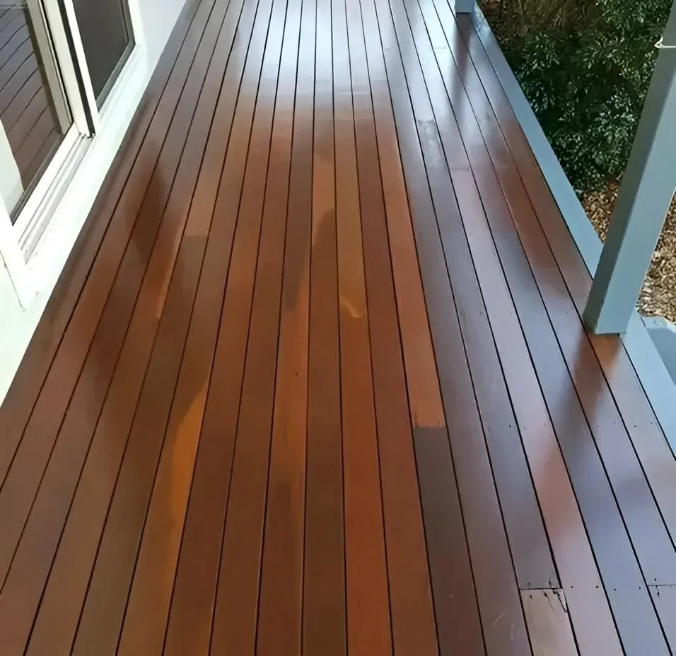 A Wooden Deck With a White Railing and a Window — Alan Aldridge Floor Sanding in Urraween, QLD