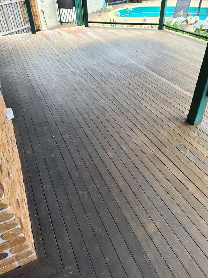 A Wooden Deck With a Pool in the Background — Alan Aldridge Floor Sanding in Urraween, QLD