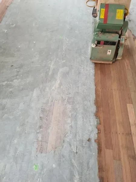 A Machine is Being Used to Sand a Wooden Floor — Alan Aldridge Floor Sanding in Urraween, QLD