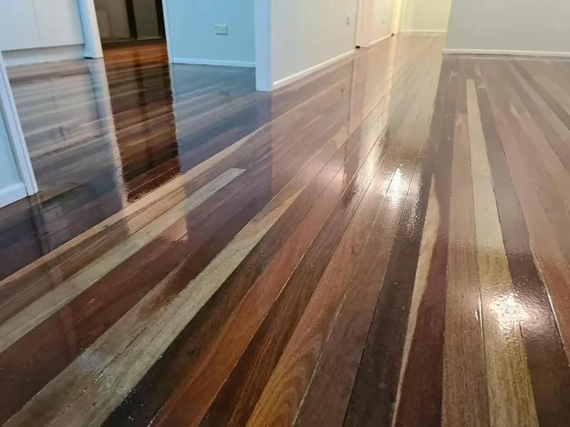 A Wooden Floor in a Room With a Reflection of a Door — Alan Aldridge Floor Sanding in Urraween, QLD