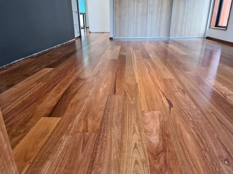 A Room With a Wooden Floor and a Sliding Glass Door — Alan Aldridge Floor Sanding in Urraween, QLD