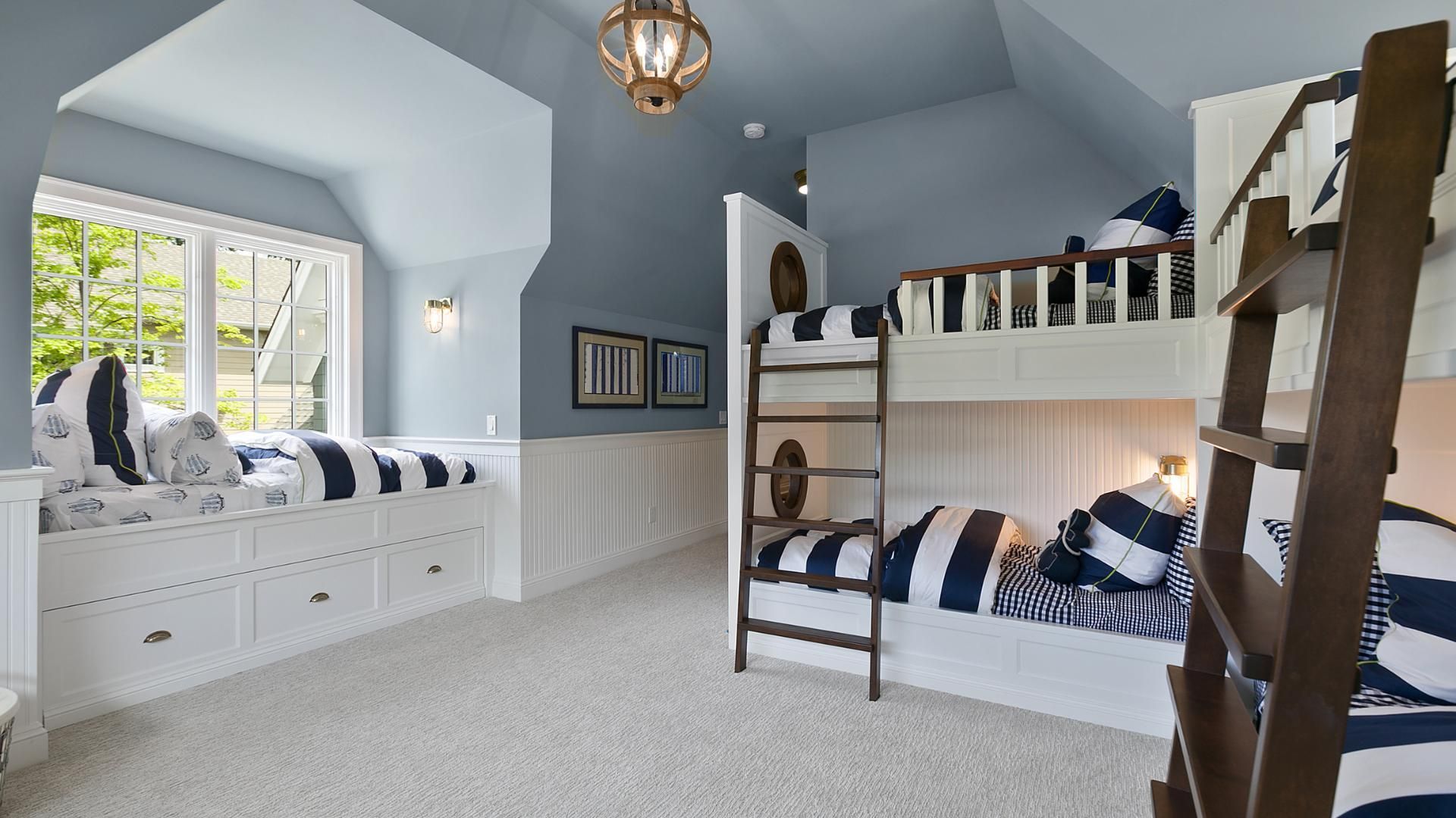 A bedroom with bunk beds and a window seat