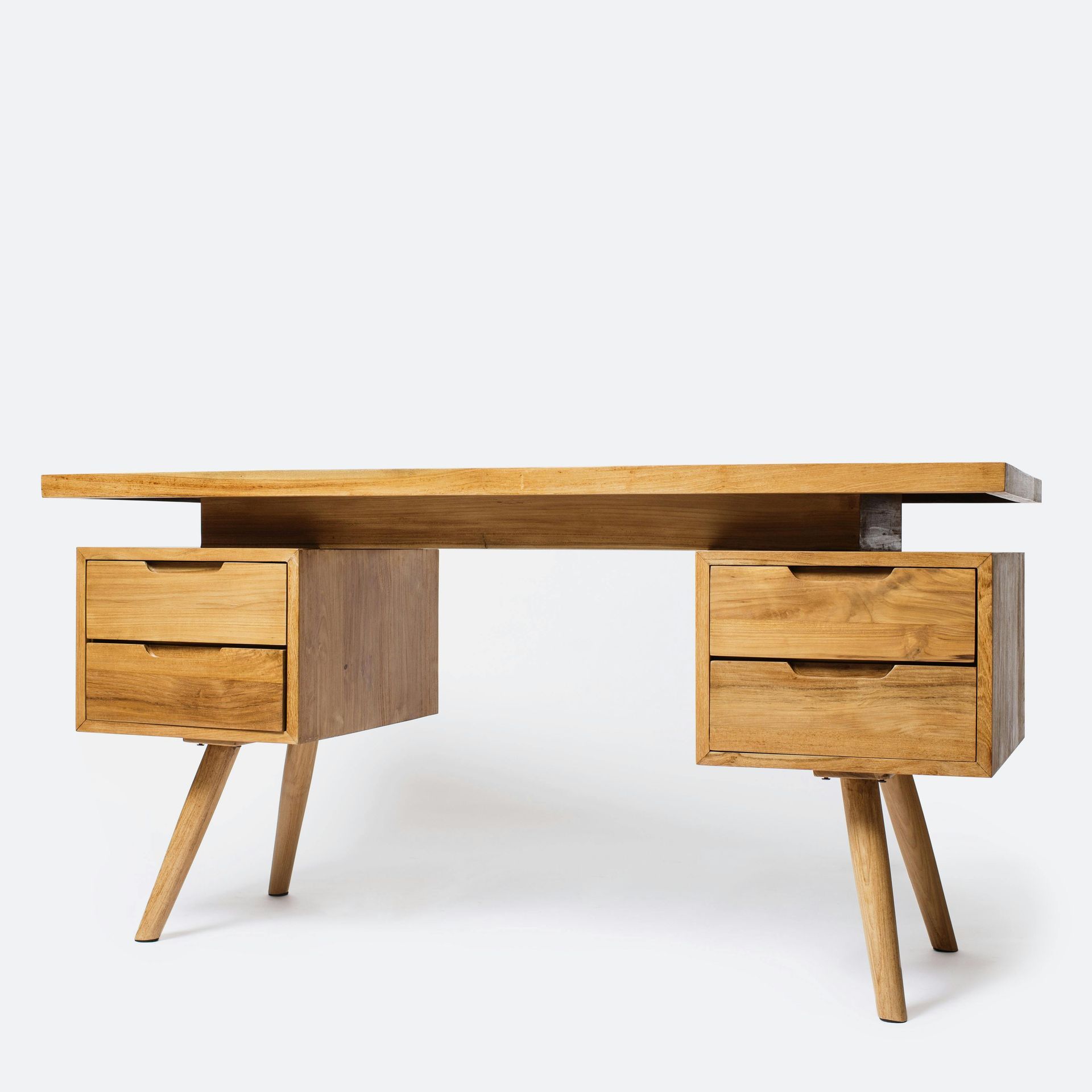 Wooden desk with drawers, supported by angled legs, against a white backdrop.