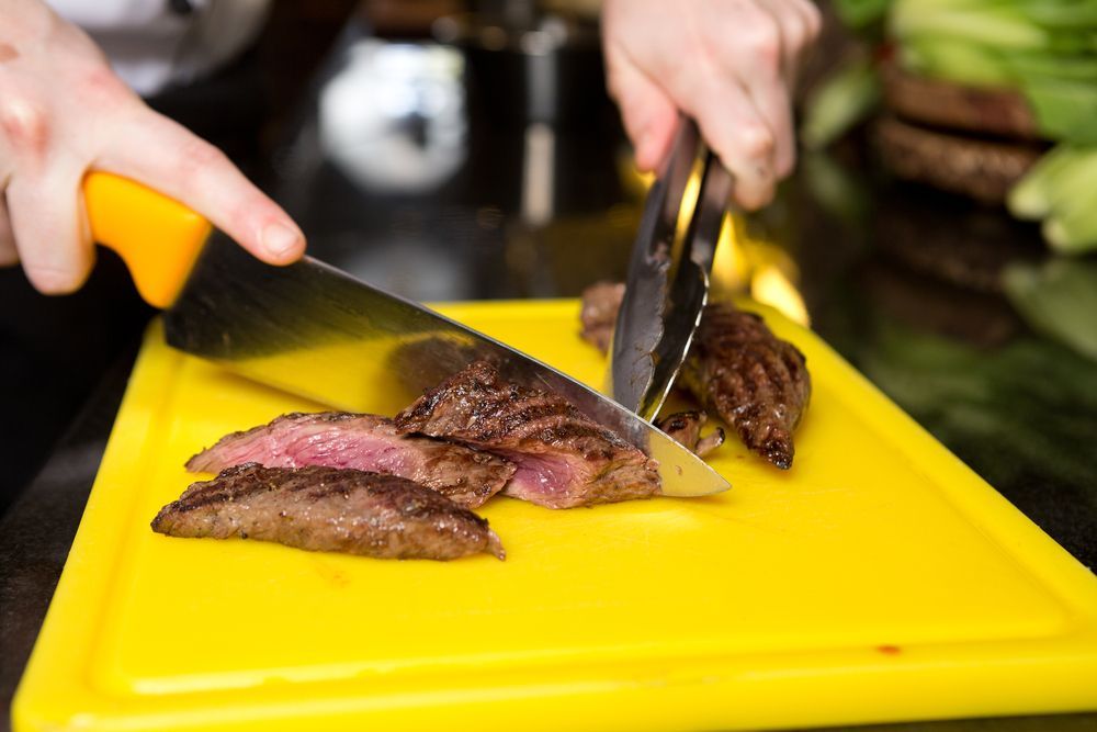 Cutting Flame Grilled Meat — NQ GAME MEAT in Currajong, QLD