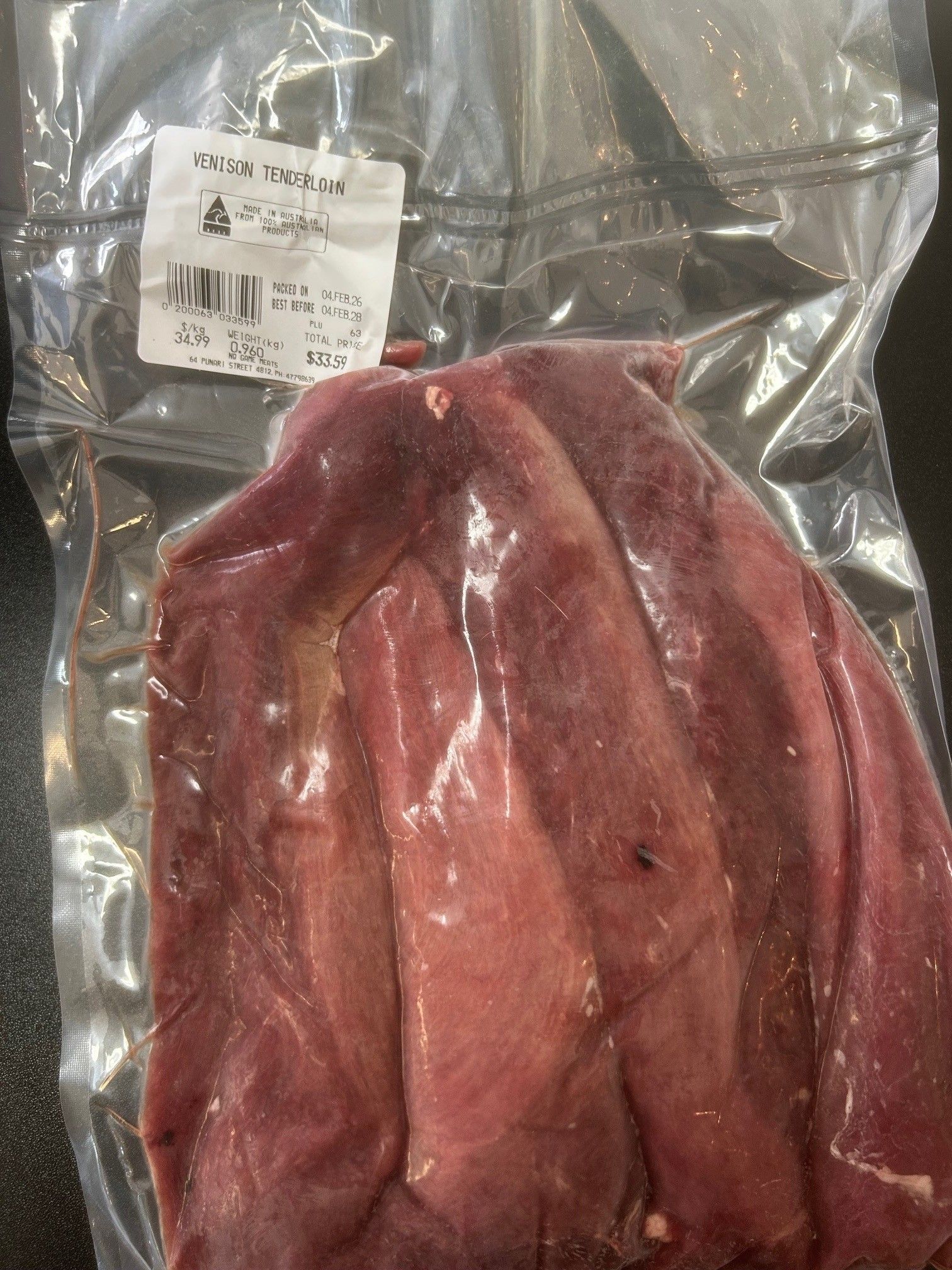 Vacuum-sealed package of raw, dark red meat with a white label — NQ GAME MEAT in Currajong, QLD