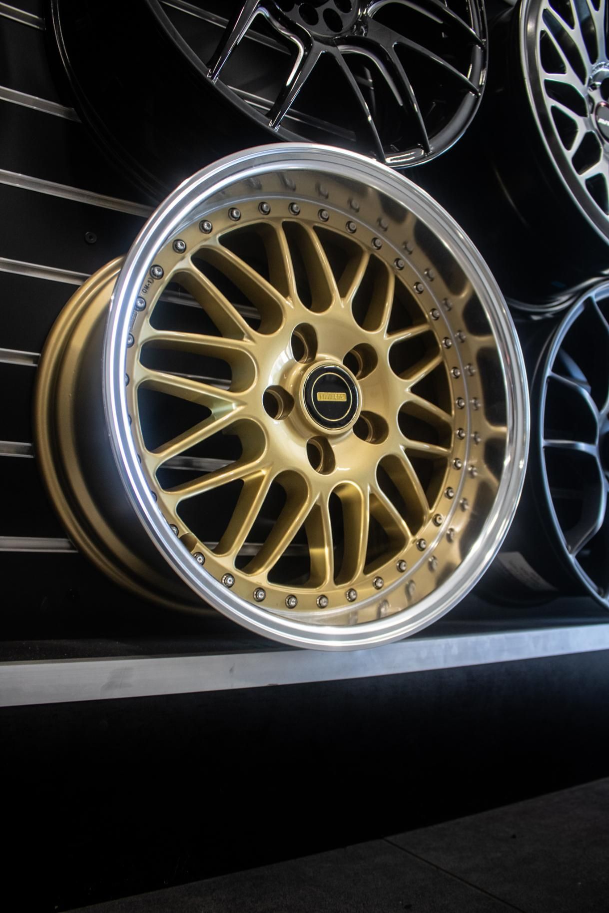 Gold Wheel Sitting On A Shelf Next To Other Wheels — Tyre Master Albury In East Albury, NSW