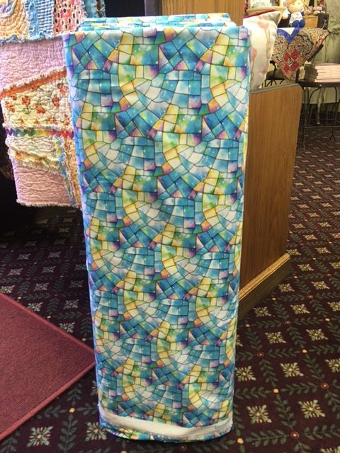 Colorful mosaic-patterned rectangular column or display pedestal in an indoor setting