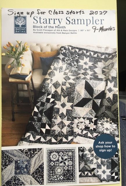 Black-and-white star quilt pattern on a magazine cover, draped over a chair in a cozy room.