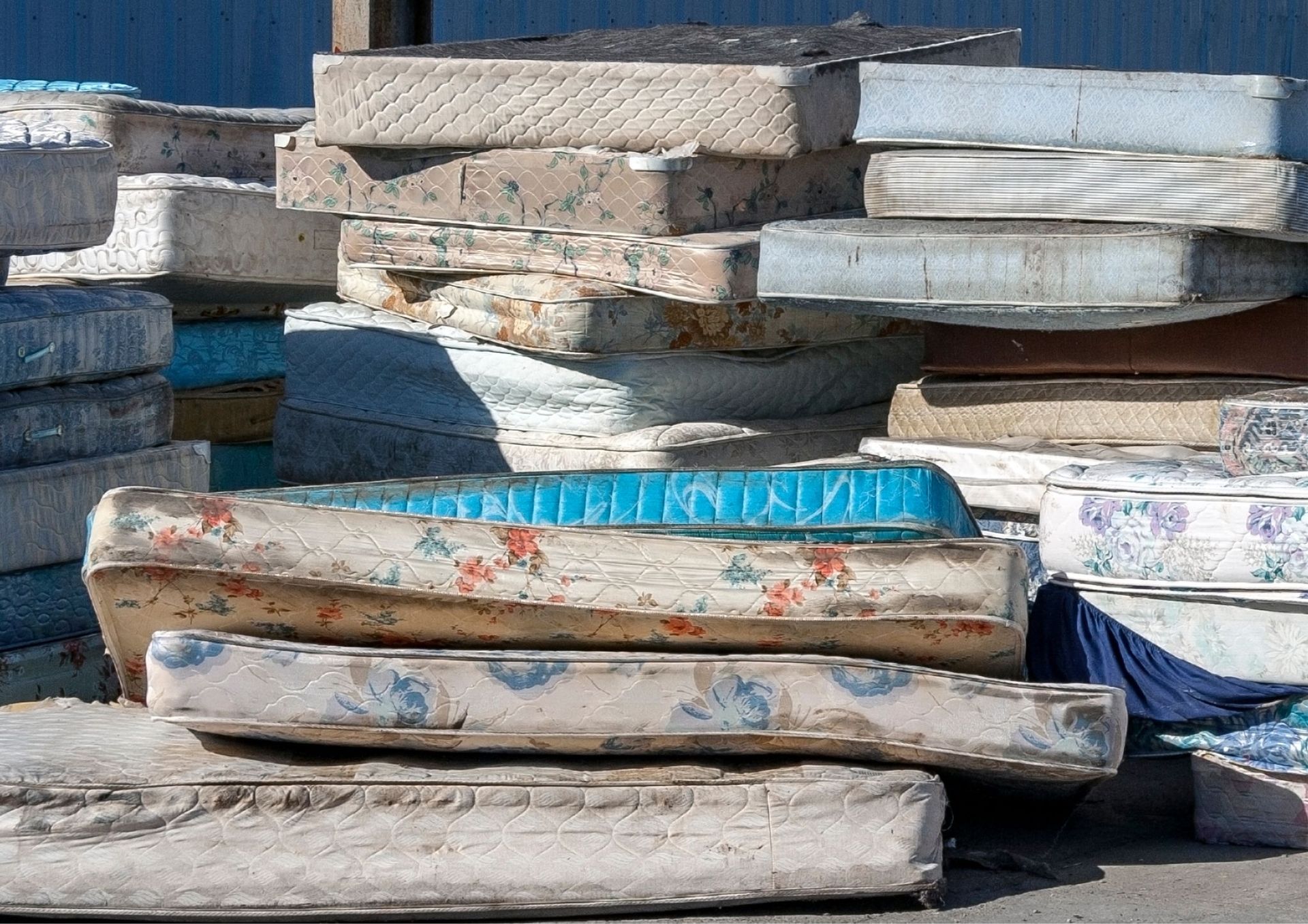 A pile of mattresses are stacked on top of each other