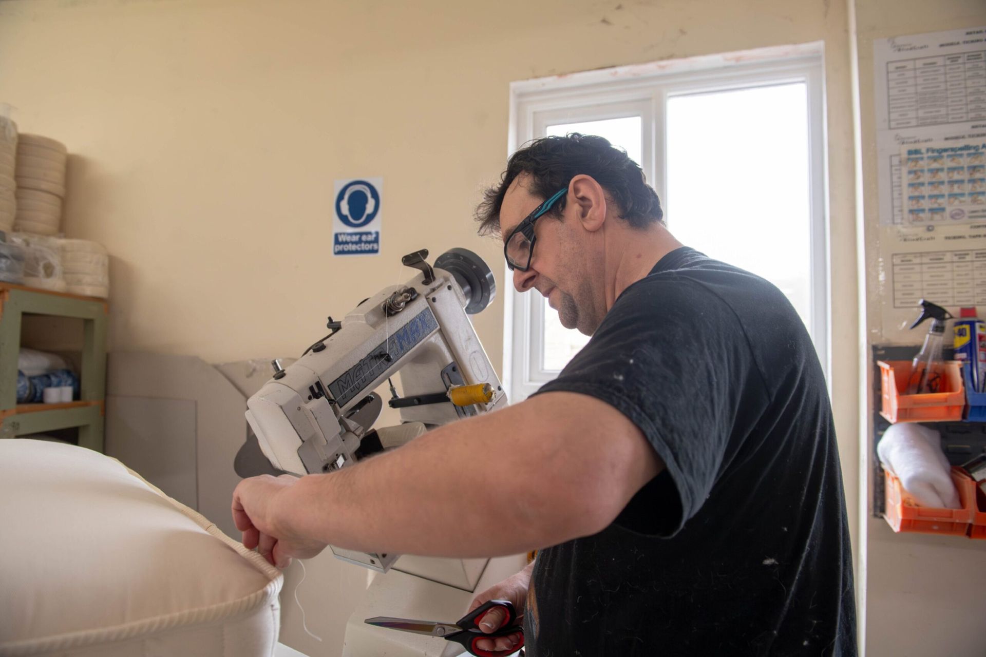 Paul, a gentleman with black hair and wearing a black tshirt works at a mattress machine