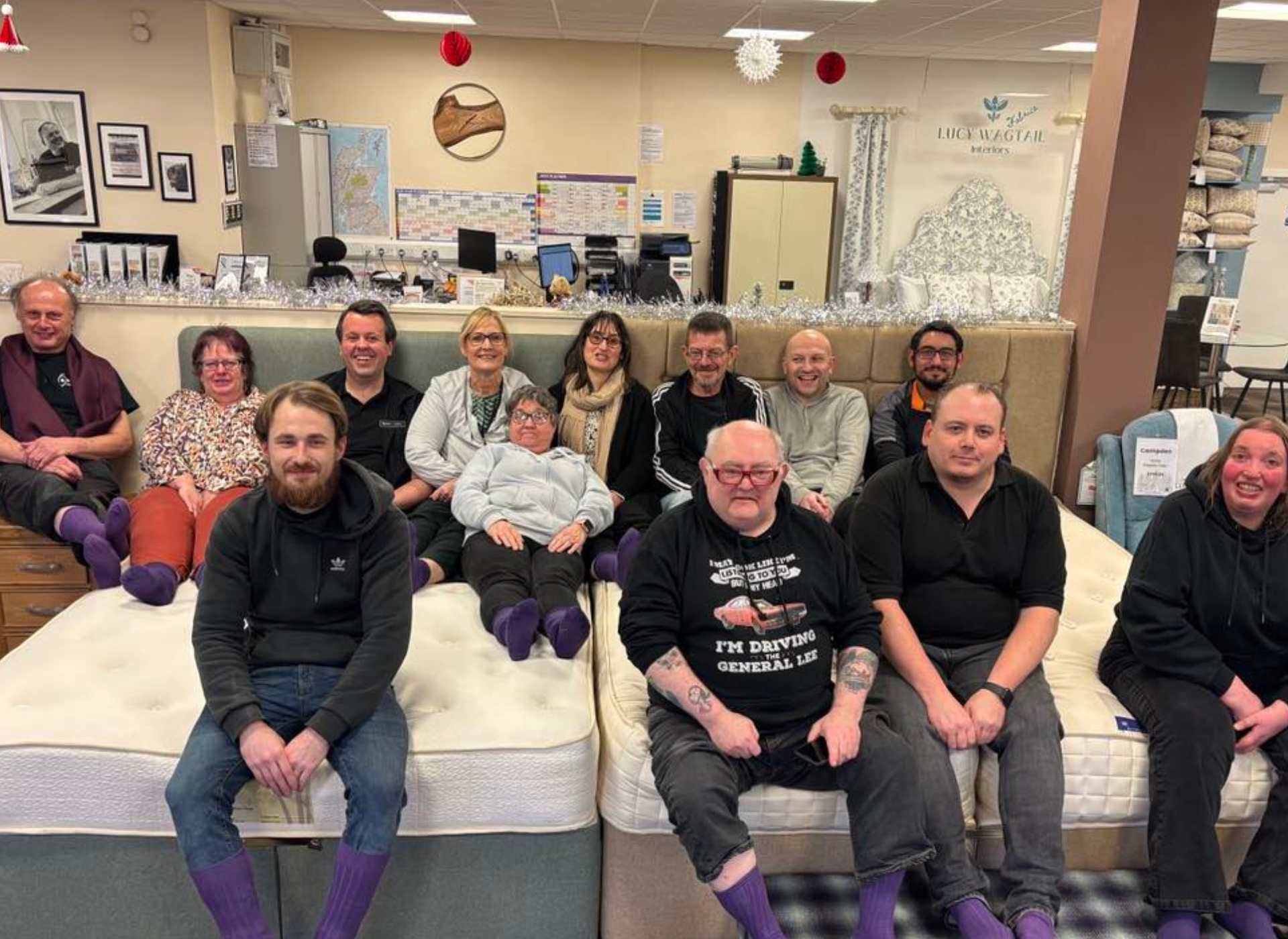 The complete team wearing purple socks for an anniversary 