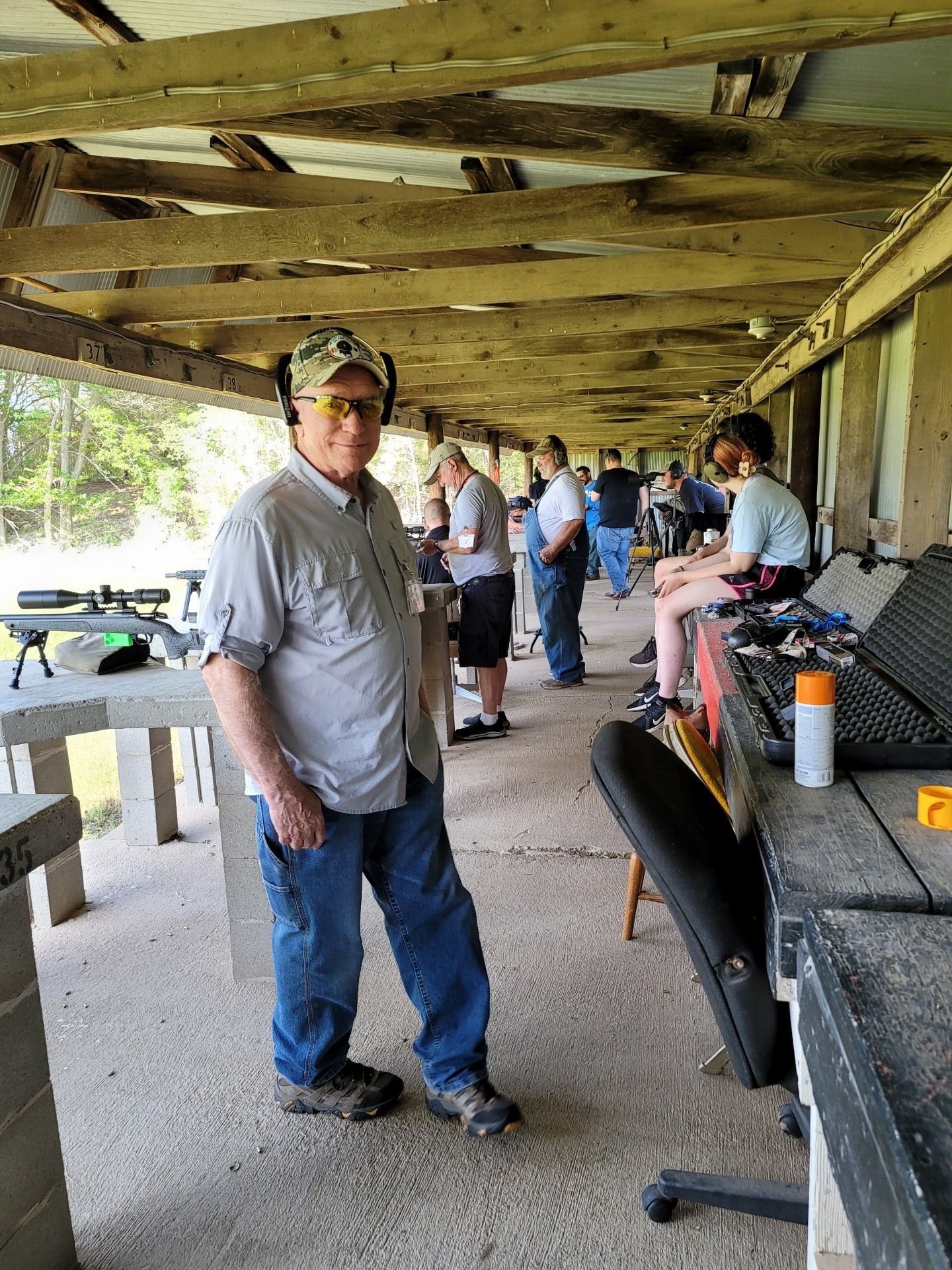 photo of several men and woman standing at gun range