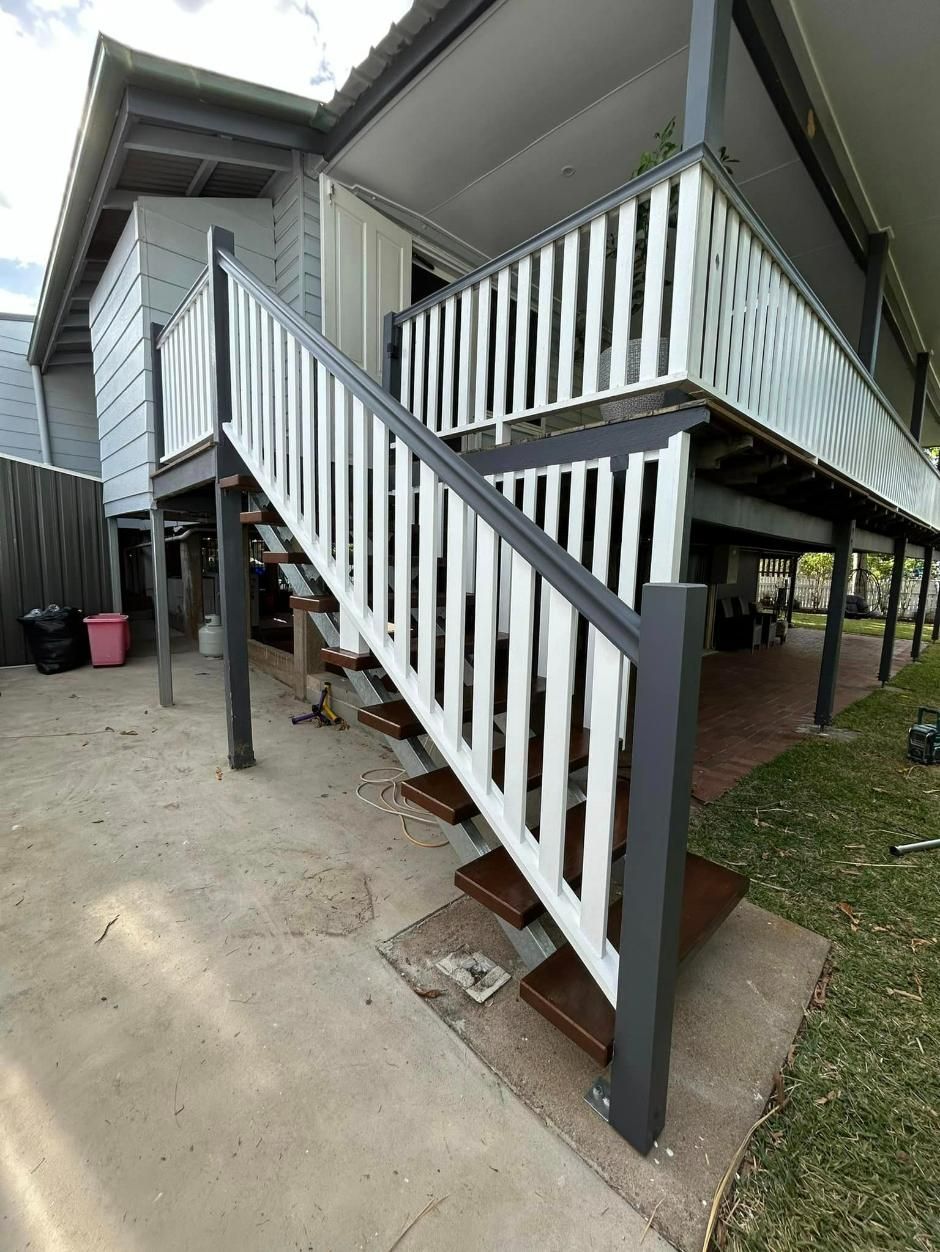 Woman is Walking Up a Set of Wooden Stairs — Ironbark Built Townsville in Currajong, QLD