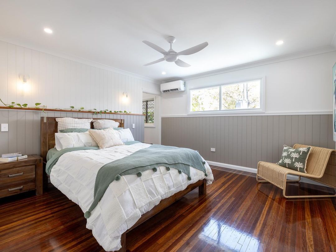 Bedroom with A Bed, Chair, Nightstand and Ceiling Fan — Ironbark Built Townsville in Currajong, QLD