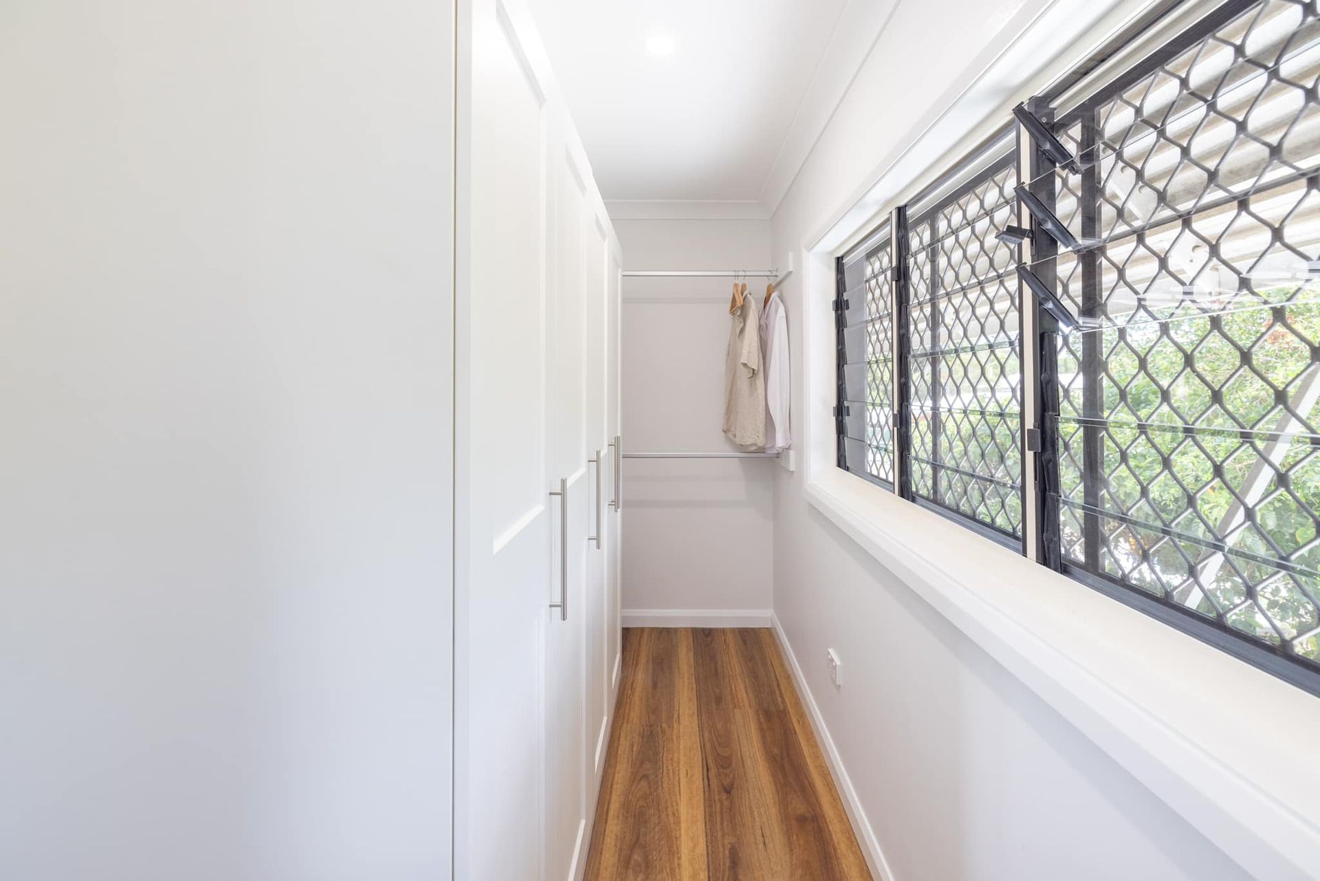Walk-In Closet With White Cabinets And Windows — Ironbark Built Townsville in Currajong, QLD