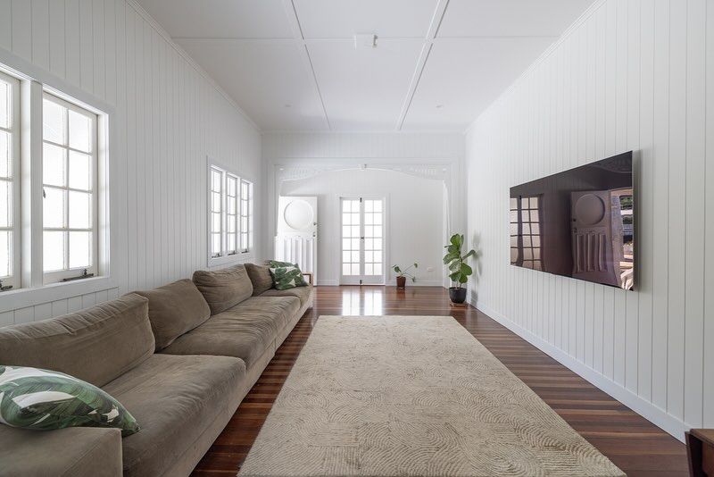 Living Room with A Large Couch and A Flat Screen TV on The Wall — Ironbark Built Townsville in Currajong, QLD