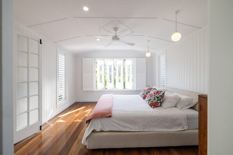 White Bedroom With Wooden Floors And Pendant Lights — Ironbark Built Townsville in Currajong, QLD