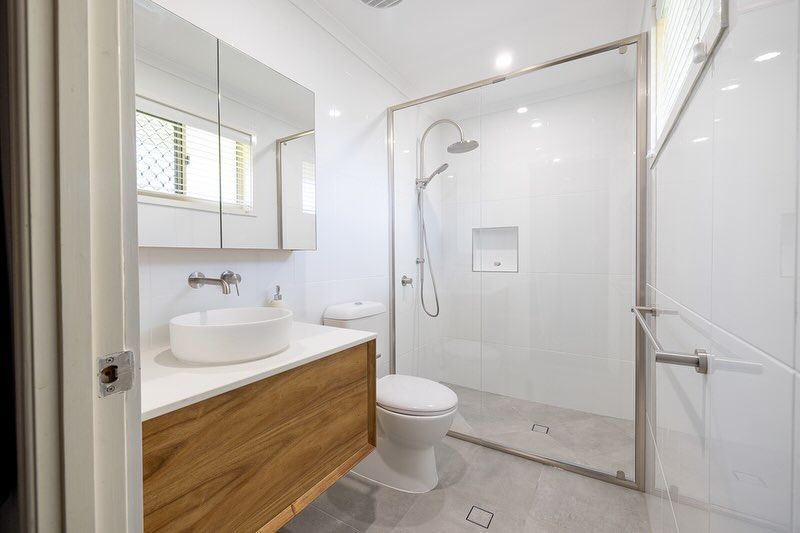 Bathroom With A Toilet, Sink, and Walk-In Shower — Ironbark Built Townsville in Currajong, QLD