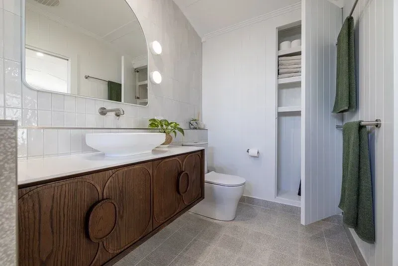 A Bathroom With a Sink, Toilet and Mirror — Ironbark Built Townsville in Currajong, QLD
