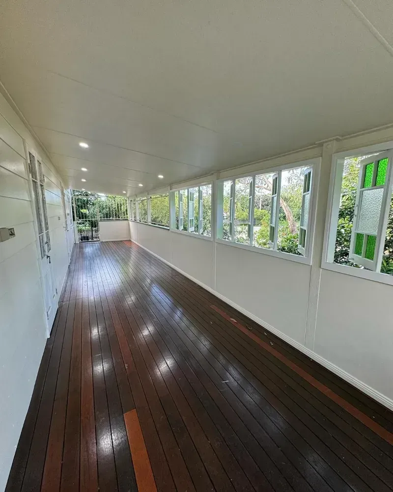 A Long Hallway With Wooden Floors and Lots of Windows — Ironbark Built Townsville in Currajong, QLD